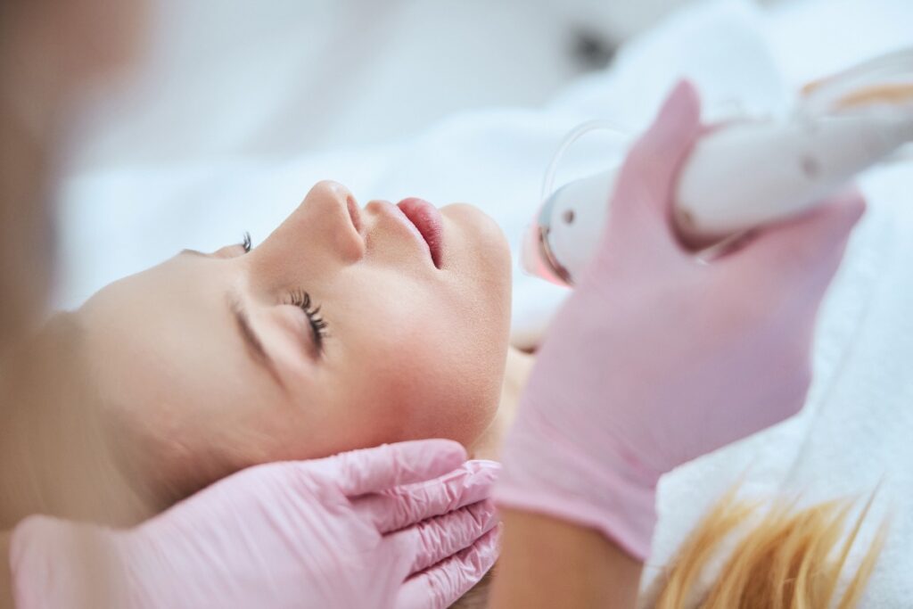 Blonde woman receiving the fractional microneedling treatment jpg